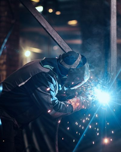 Welding work with metal construction at busy metal factory